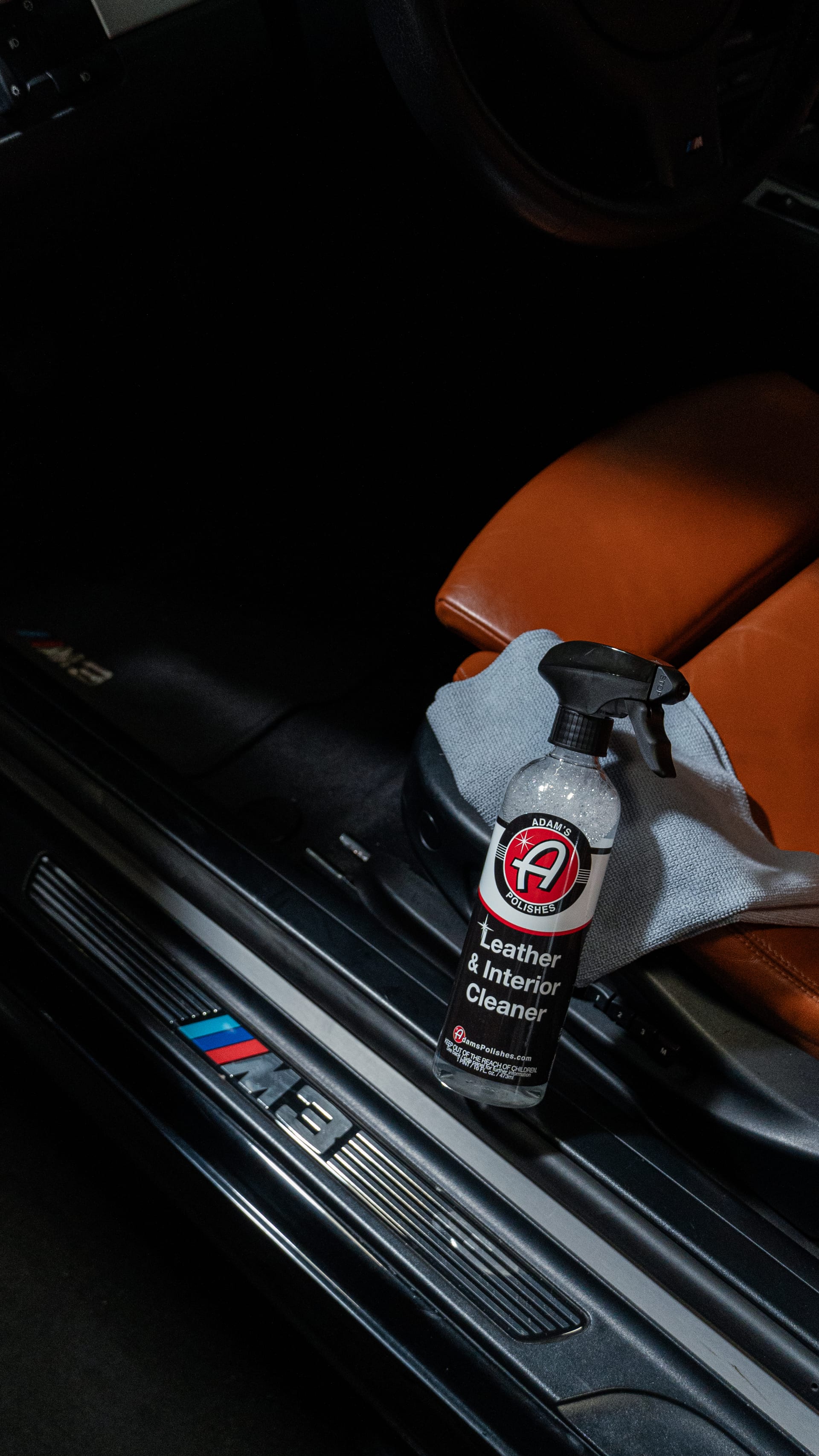 Interior detail — Adam's leather and interior cleaner on a BMW M3 with brown leather